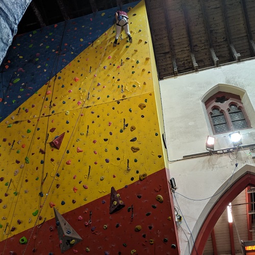 Lily tries her hand at a climbing wall at her local climbing centre